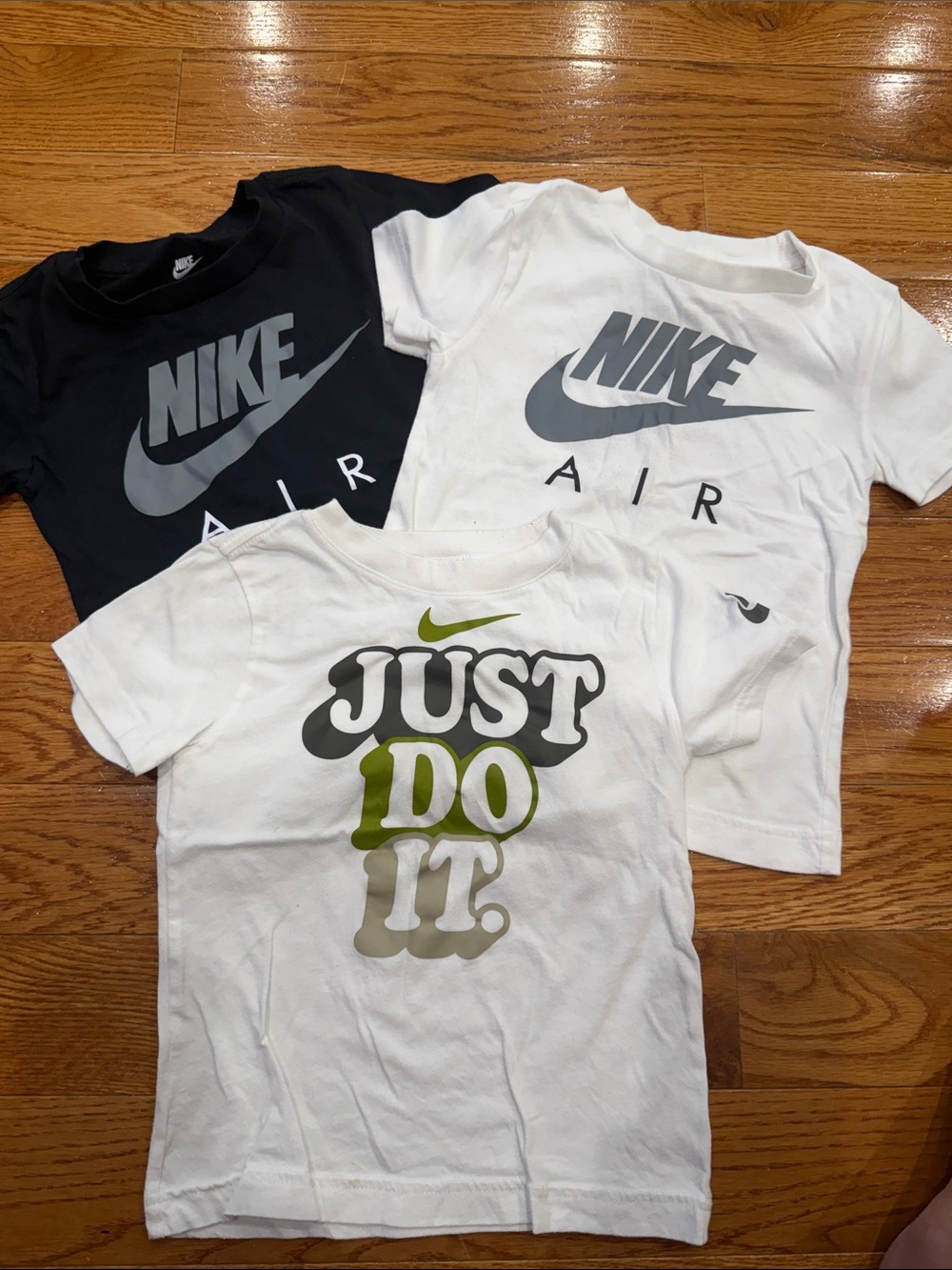 Nike Kids Short Sleeve Graphic Tees - White, Black, Green Accent.